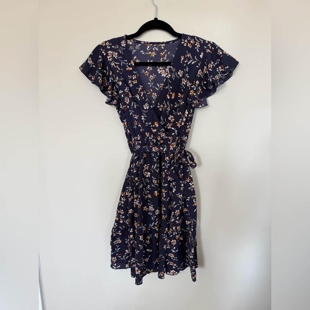 Floral Navy Wrap Dress with ruffle sleeve and tiered skirt. Size small.